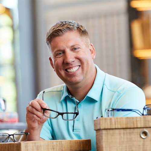 Man sitting next to glasses