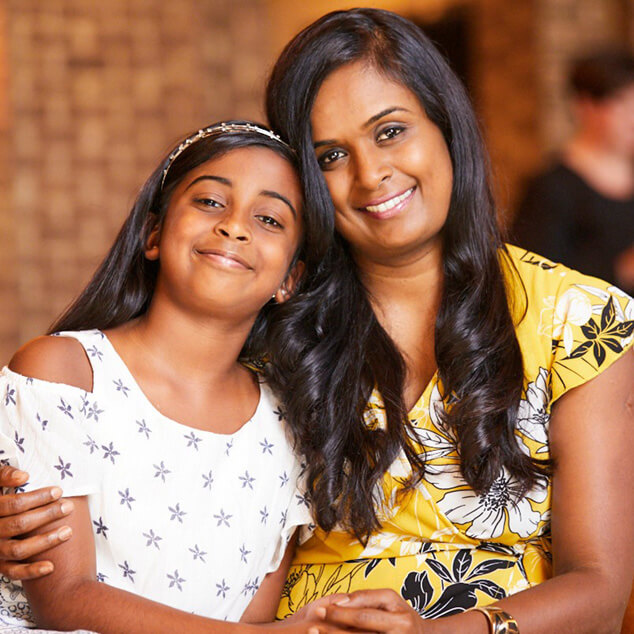 Mother and Child Holding Hands and Smiling